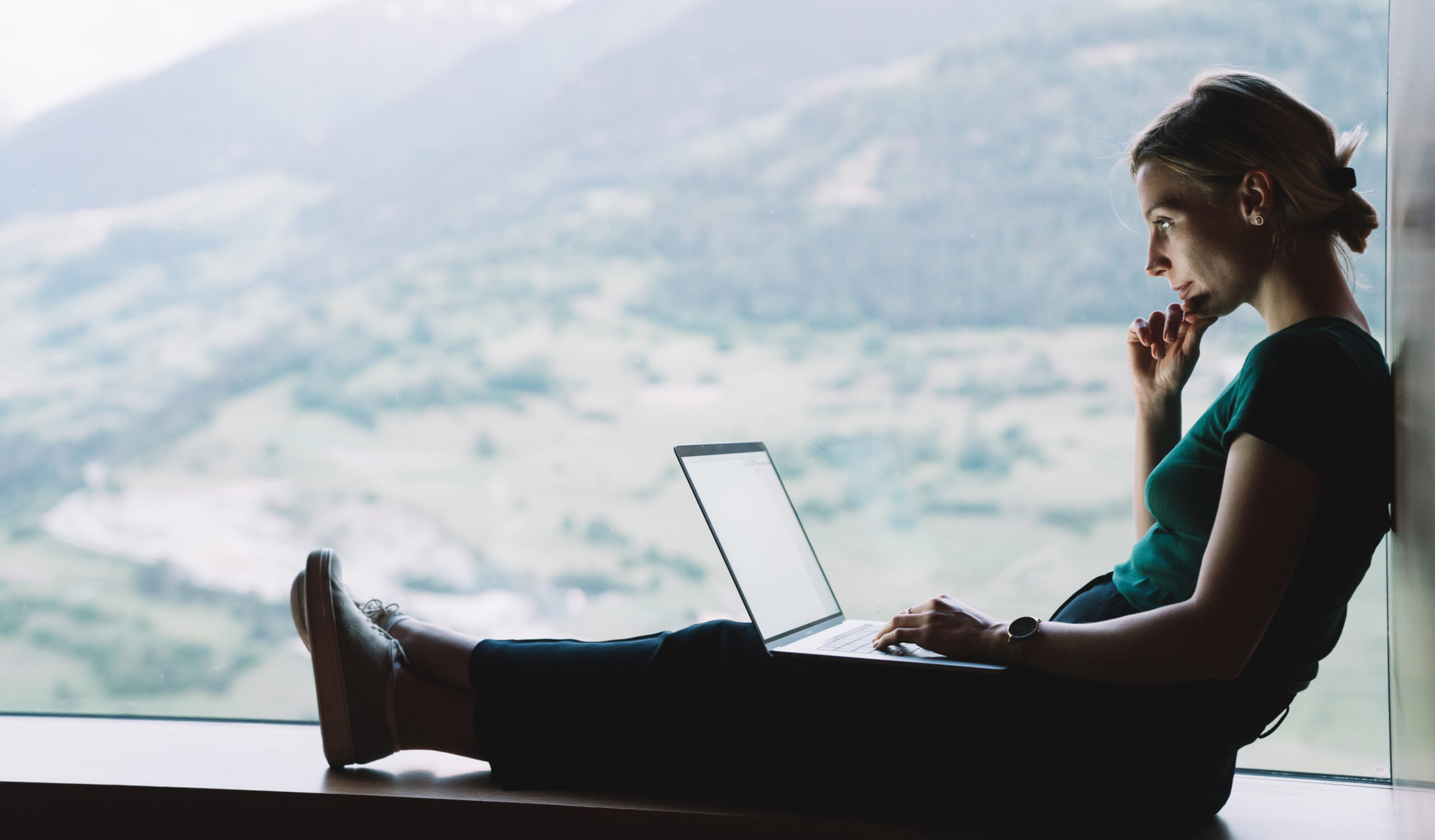 person working remotely on laptop representing AI-supported digital workflows and productivity
