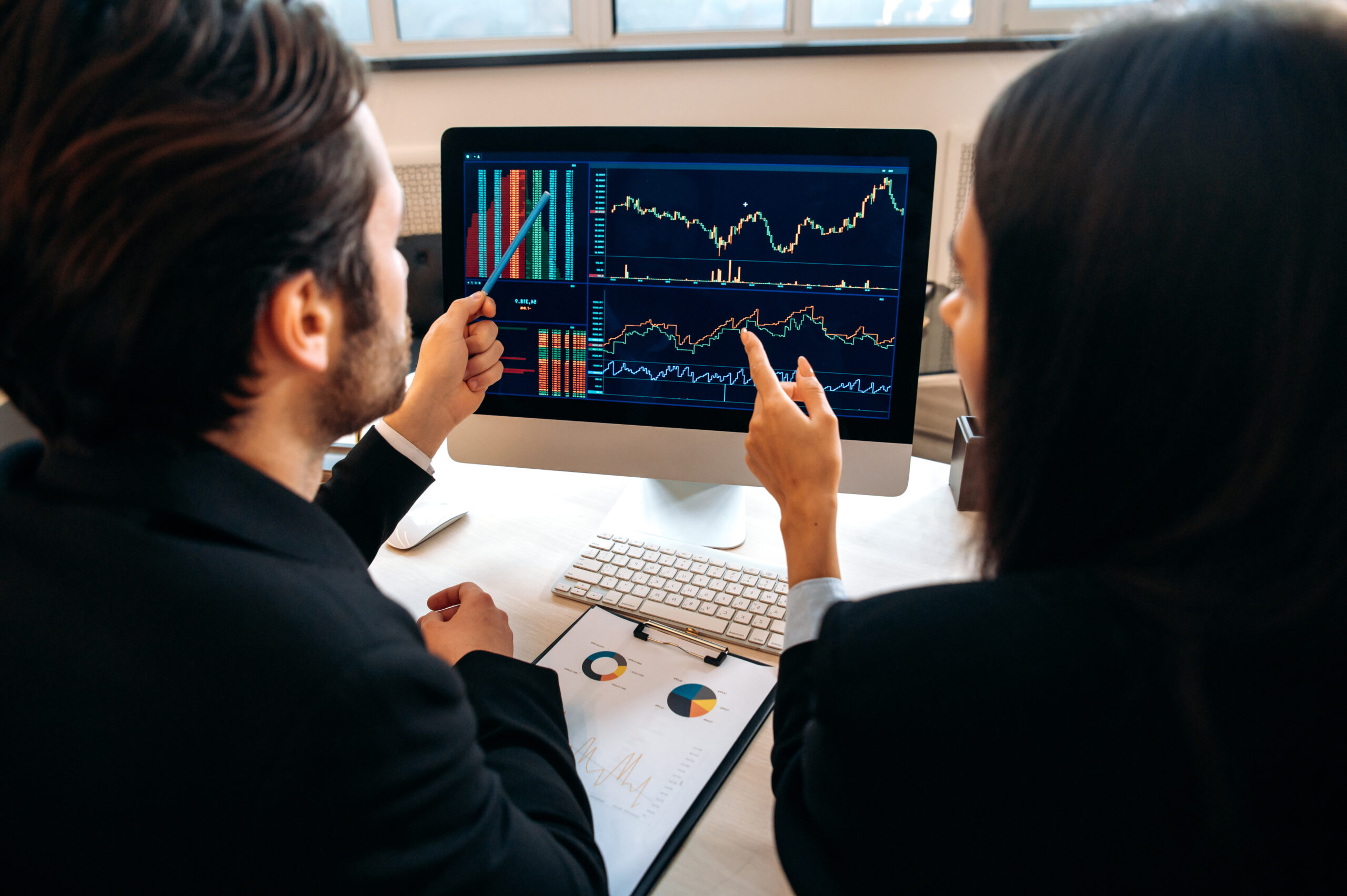 team reviewing analytics dashboard on computer representing AI-driven decision-making and workflow collaboration