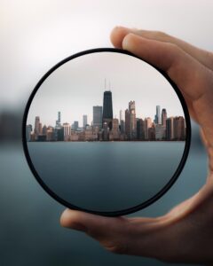 city skyline viewed through circular lens representing AI-driven data filtering, clarity, and insight analysis
